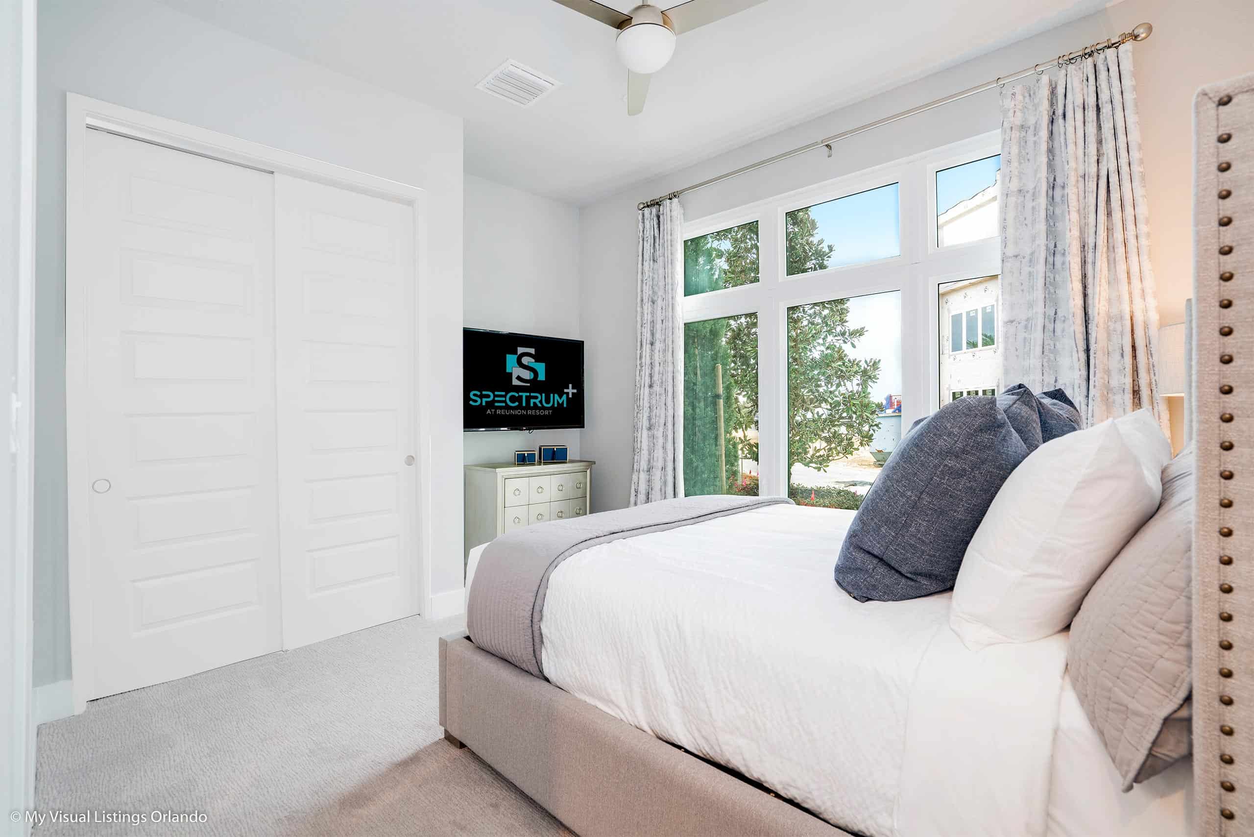 Home 15 Furnished Bedroom With Tv And Large Window In A Spectrum Resort Orlando Residence.